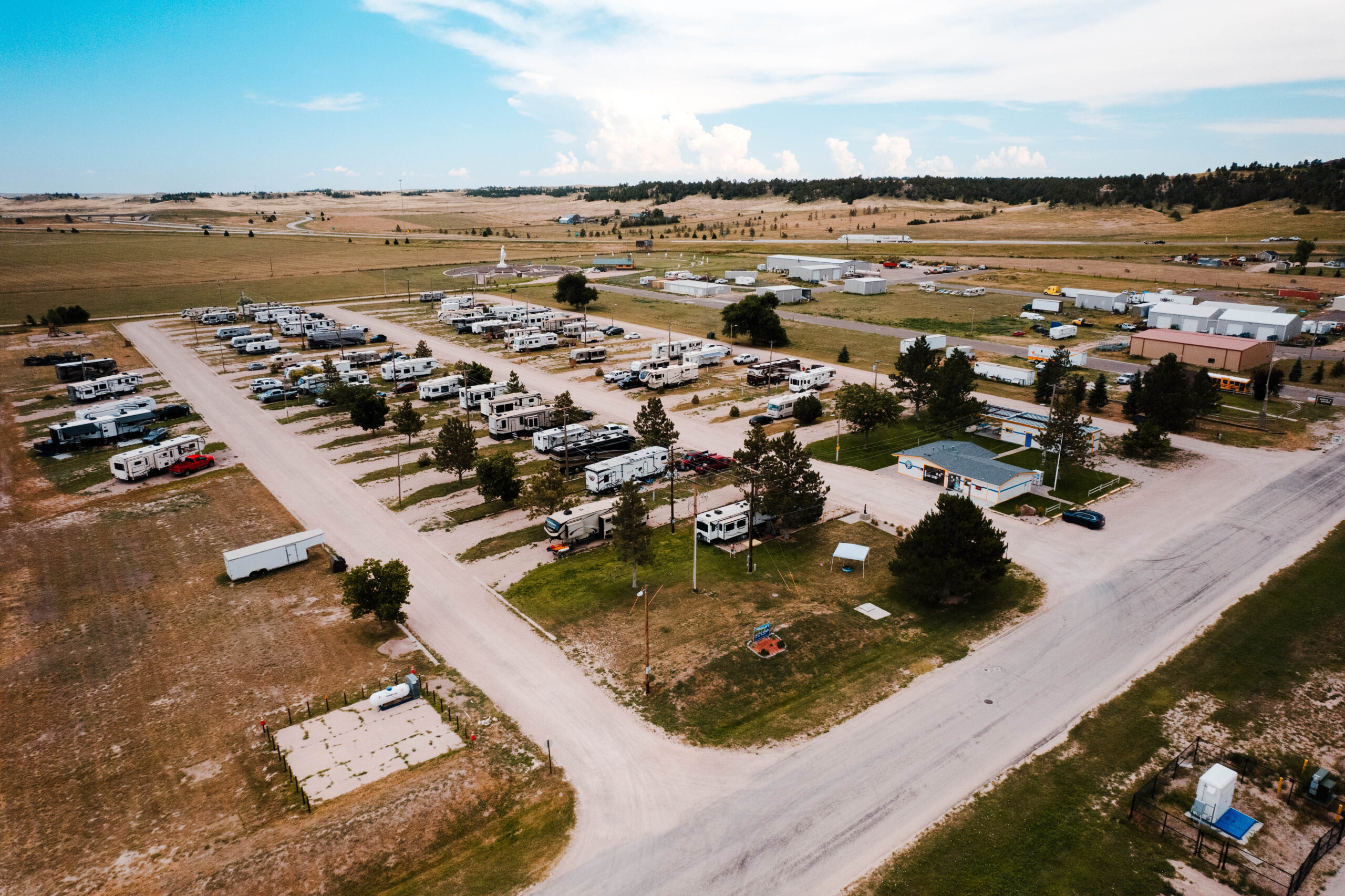 Panoramic view of Pine Bluffs RV Park by RJourney with open Wyoming sky and full hookup sites