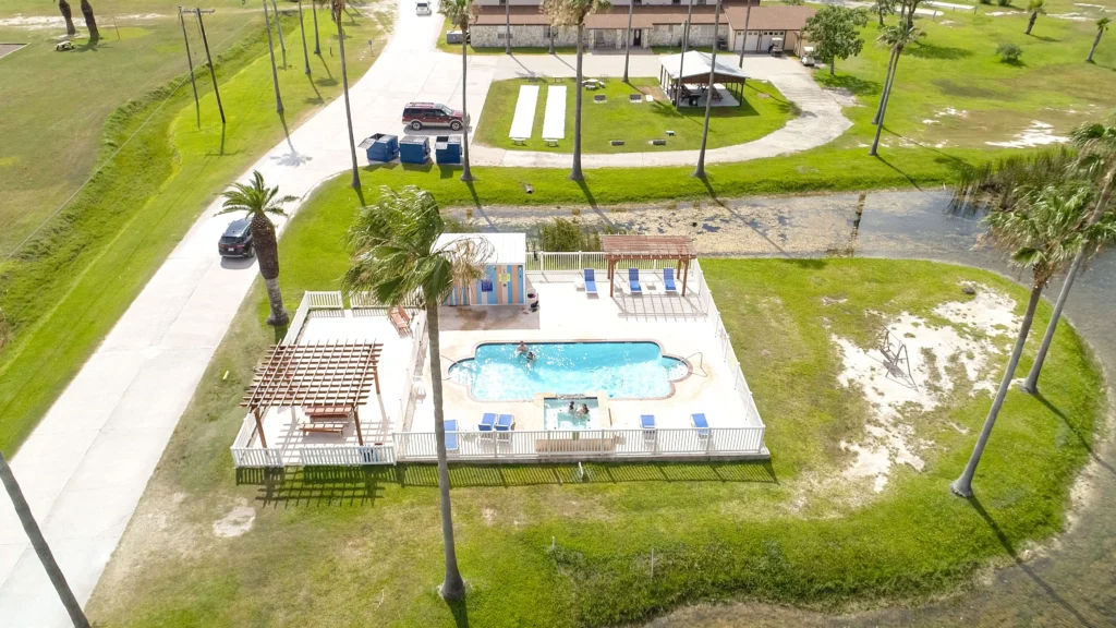 Aerial view of Rockport RV Resort by RJourney with Palm Trees and Pool in the foreground
