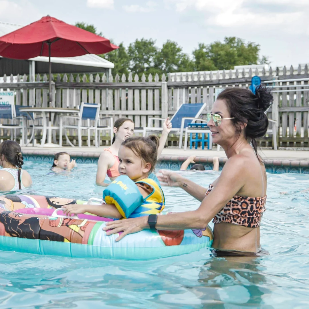 A woman plays with her children at the Lakeside RV Resort pool.