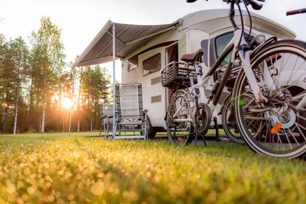An RV all set up with pop outs and a bike ready to ride.