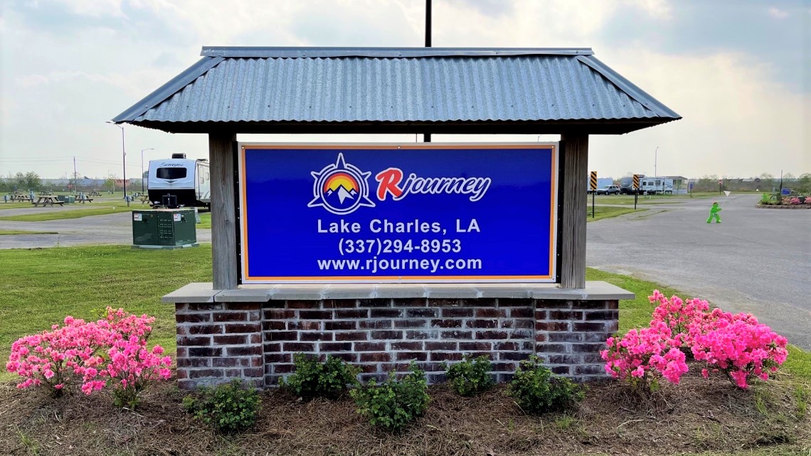 Level sites with paved streets and a bathhouse at Lake Charles RV Resort in Iowa, Louisiana